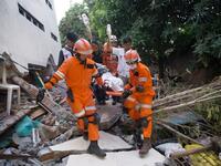 Rescue personnel evacuate earthquake survivor Ida, a food vendor, from the rubble of a collapsed restaurant in Palu, Indonesia's Central Sulawesi on September 30, 2018. (BAY ISMOYO / AFP)