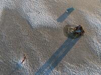 An aerial view shows a man sitting near a hole drilled into the frozen sea using an auger (L), as he ice fishes on the Gulf of Bothnia, near Vaasa, Western Finland on December 28, 2018, where winter daylight last for some four hours. 
Olivier MORIN / AFP