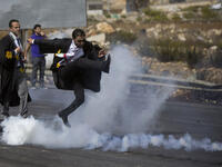 palestinian lawyer kicks tear gas can
