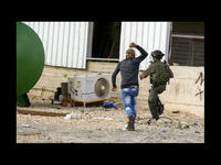 palestinian chases israeli soldier with stone