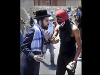 orthodox jew and palestinian throw stones together