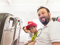 Arab man and kids plane seats looking up