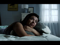 woman crying bed