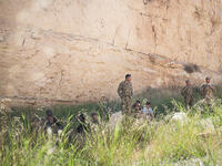 Jordan's team rests in the shade of a sandstone cliff before the Warrior Competition "urban assault" event where soldiers rush over a dirt verge, storm a building in a mock city, and rescue a hostage. Jordan's special forces have joined the ongoing fight against Daesh, when a militant cell was uncovered in northern city, Irbid.