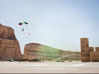 A parachuter from Jordan 71st counter-terrorism battalion prepares to land during the opening ceremonies of the seventh annual Warrior Competition at the King Abdullah II Special Operations Training Center near Amman, Jordan on April 19, 2015. This annual military competition brings together elite special operations teams from around the world.