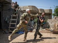 Nicknamed by Kurdish fighters, Canadian "Hewal Zinar,” 67, and Briton “Hewal Cudi,”40, train on the outskirts of the Syrian border town of Tal Tamr on April 19, 2015. Fighters come from a diverse range of military backgrounds and have poured into Syria to fight alongside Kurdish People's Protection Units (YPG.)