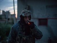 A 41-year from the US, nick-named ‘Hewal Azad,’ smokes a cigarette outside Tal Tamr on April 15, 2015.
