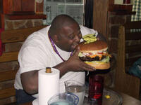 man eating huge burger 