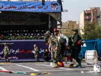 This picture taken on September 22, 2018 in the southwestern Iranian city of Ahvaz shows Iranian soldiers carrying away an injured comrade at the scene of an attack on a military parade that was marking the anniversary of the outbreak of its devastating 1980-1988 war with Saddam Hussein's Iraq. (MORTEZA JABERIAN / ISNA / AFP)