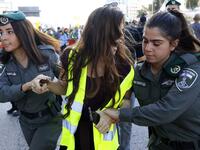 Members of the Israeli security forces arrest a protester wearing a yellow vest, during demonstrations against the rising cost of living on December 14, 2018.
JACK GUEZ / AFP