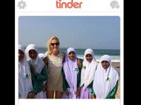 blonde woman in shorts with modestly dressed Muslims