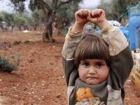 Hudea Syrian girl hands raise at camera