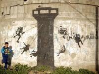 This graffiti is a carousel of children, in Banksy's typical stencil technique /AFP