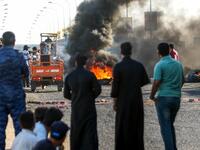 Iraqi protesters, who are demonstrating against corruption and lack of basic services, burn tires as they block the main road between the centre of the southern city of Basraon September 2, 2018. 
Haidar MOHAMMED ALI / AFP