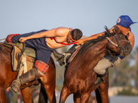Men wrestling on horseback (Shutterstock/File Photo)