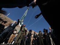Iraqi Sufi Muslim Kurds take part in a ritual ceremony to commemorate the birth of the Prophet Mohammed in .
Akra.
SAFIN HAMED / AFP