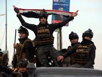 Members of the Iraqi security forces take part in celebrations marking the first anniversary of the country's victory over the Islamic State (IS) group, in the northern Iraqi city of Mosul, on December 10, 2018.
Zaid AL-OBEIDI / AFP