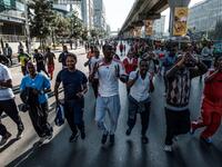People take part in an exercise on a street in Addis Ababa on February 3, 2019 during the third Car Free Day promoted by local NGOs and the Ethiopian Government to appeal to a healthy life style and a less air pollution of the capital city. 
EDUARDO SOTERAS / AFP