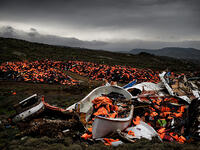 The debris of displacement: Thousands of discarded life jackets and plastic boats sits on a hillside on the Greek island of Lesbos. 