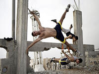 Palestinian men practice street workouts, using the rubble of war-torn Gaza as their gym. 