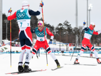 Norway's Simen Hegstad Krueger gold medallist, celebrates as countrymen silver medallist Norway's Martin Johnsrud Sundby arrive at the finish line at the end of the men's 15km + 15km cross-country skiathlon during the Pyeongchang 2018 Winter Olympic Games on February 11, 2018. (Jonathan NACKSTRAND / AFP)