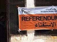 a Southern Sudanese woman carries her baby as she leaves after registering at a center to vote in the upcoming referendum on the south's independence from the north, in al-Fasher, the capital of north Darfur. 