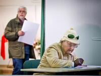 A woman marks her vote on a ballot paper at a polling station in Warsaw during Poland's local elections. Polling stations opened across Poland in the first round of local elections, seen as a key test for the governing liberals before general elections in late 2011.