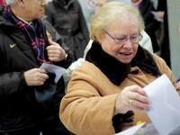 A woman casts her vote in the regional elections in Catalonia, in Barcelona. Polls indicate voters in what has traditionally been Spain's economic powerhouse will kick out the Socialist-led coalition in favour of the moderate centre-right nationalist Convergence and Union (CiU) coalition. 