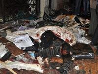 The body of an Egyptian Coptic man is seen on the ground following a car bomb attack outside the Al-Qiddissine church.