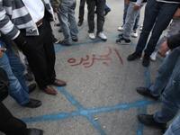 Palestinian protesters step on a Star of David sprayed on the ground with the name of the Al-Jazeera written in red Arabic letters in the middle during a demonstration in the West Bank city of Ramallah.