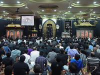 Ashura, aside from the general sombre tone to the day, is actively made up of mourning rituals and passion plays re-enacting
the historical martyrdom and suffering. While centered in the more widely recognized, high profile outdoor parades, there is also
activity in indoor congregation halls known as Hussainia (pictured).