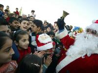 Mainly Iraqi Kurd children gather to greet Santa Claus in the northern Iraqi city of Arbil on Christmas eve.