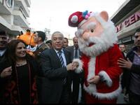 Palestinian prime minister Salam Fayyad (C) shakes hands with a man dressed as Santa Claus as he takes part in the 3rd annual march for unity and peace marking Christmas in the biblical West Bank town of Bethlehem.
