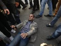 A wounded Egyptian demonstrator lies on the ground during clashes with Egyptian police.