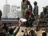 An Egyptian soldier raises an infant of the Protest in testimony to the good feeling between the Military and the People this last week.