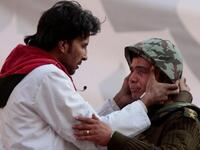 A People's Doctor is applying his healing hands to an Egyptian soldier who cries guilty tears of apology for not having been able to protect his people from the pro-Mubarak stampede.