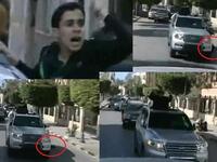 Fist-air-punching Gaddafi on his latest public outing:– his boy supporter falls flat from the Gaddafi-car-mobile, and Gaddafi only momentarily glances at him before carrying on thumping the air, unfazed.