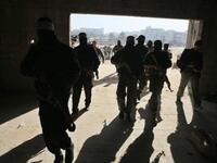 Armed Palestinians are seen giving a press conference to mark the second anniversary of Israel's three-week offensive on the Gaza Strip.