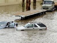 Saudis leave their vehicles in a flooded street following heavy rain in the Red Sea port city of Jeddah.