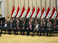 Iraqi Prime Minister walks towards his seat past members of his new cabinet during a parliamentary session in Baghdad in which lawmakers unanimously approved the new government to be headed by the incumbent Shiite premier.