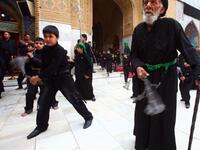 Shiite Muslim men and lads flagellate themselves with chains in an Ashura ritual in the shrine city of Karbala in central Iraq.