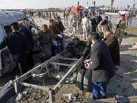 Members of Iraq security forces gather on the site of an explosion in Karbala.