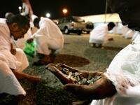 One leaves Arafat after sunset, reaching Muzdalifah by evening of 9th Dul-Hajj. Prayers are 
offered. The pilgrims spend the night, not before gathering together 49 or 70 small stones for use the next day.
 (Health & safety: bags of tiny pebbles or even gravel are sold to prevent injuries, together with safer fare-ways in place for positioning.)