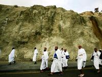 The passage or pilgrimage begins just outside Mecca, at Miqat, or entry station to the Hajj. When the pilgrim reaches
Miqat, fully washed & in correct attire (Ihram), they say 'Talbiyah'- a vow to perform Hajj. After reaching Mecca, 
one should head straight to Ka’aba ,in the vicinity of Masjid-el-Haram, and perform 'Tawaaf' (circumambulation).