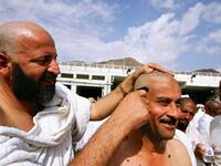 After offering the sacrifices, a male pilgrim should have his head shaven and female pilgrims are required to cut a small part
of her hair, say a lock of their hair. Female pilgrims are not permitted to have their heads shaven. After the hair cut, 
one can remove the Ihram and may now wear regular clothes. 