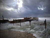  High waves flood a fish restaurant on the Mediterranean coast of the northern Lebanese port of Byblos.