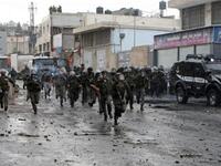 Jerusalem Jossles with its occupied side : Israeli border police take position during clashes with Palestinian demonstrators in the Shufat refugee camp on the outskirts of Jerusalem on May 15.