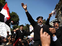 Policemen are carried during a demonstration in support of President Hosni Mubarak.