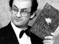 Salman Rushdie brandishes his novel Satanic Verses 