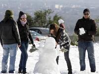 Syrians play with snow in Damascus as the Syrian capital was lashed by a snowstorm which disrupted traffic but brought some relief from a drought which has gripped the country for the past four years.